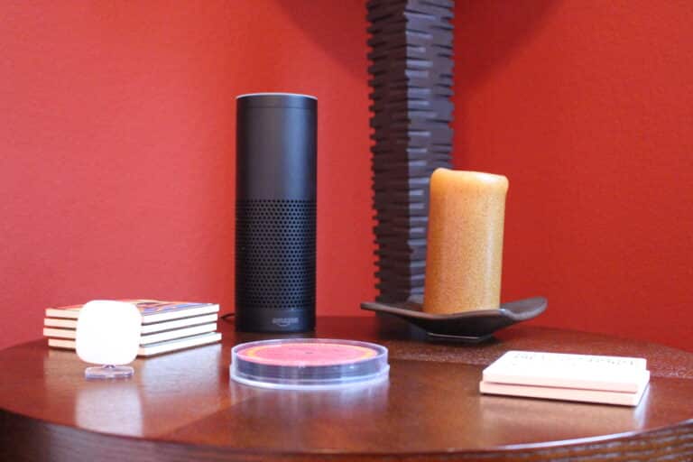 Smart assistant device placed on a table, representing the integration of smart home devices like thermostats for modern living.