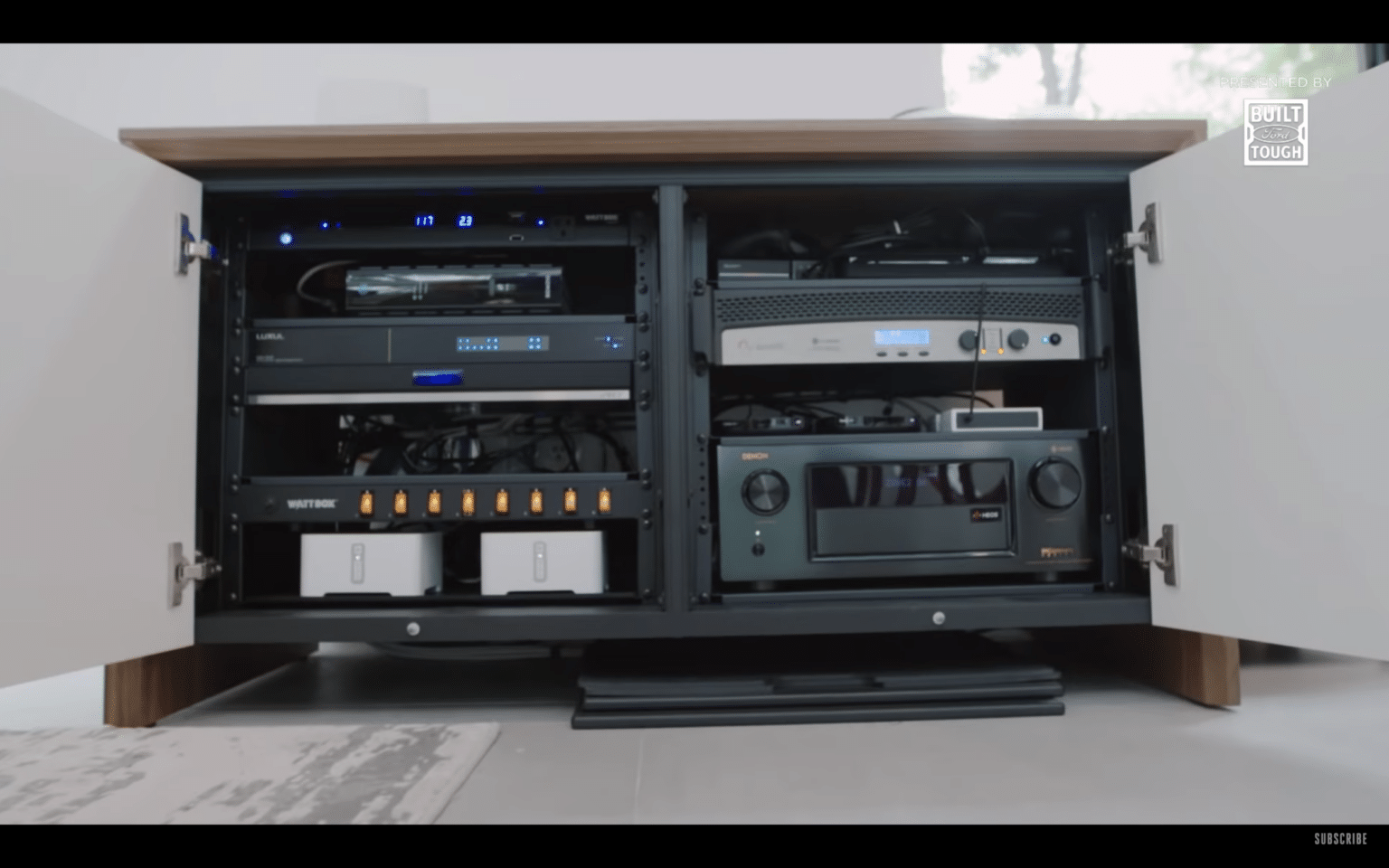 AV cabinet with amplifiers and receivers neatly organized, representing whole-home home audio systems.