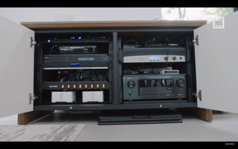 AV cabinet with amplifiers and receivers neatly organized, representing whole-home home audio systems.