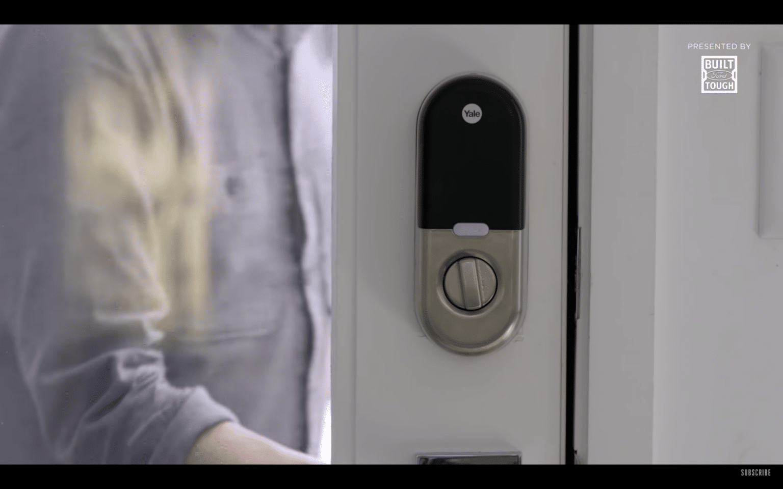Smart lock installed on a front door, integrated with a modern alarm system for home security.