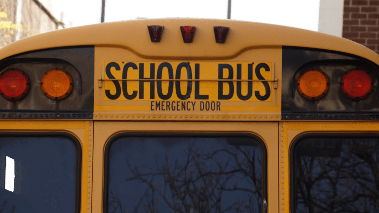 Rear view of a yellow school bus, symbolizing the connection between raising smart kids and creating smart homes.