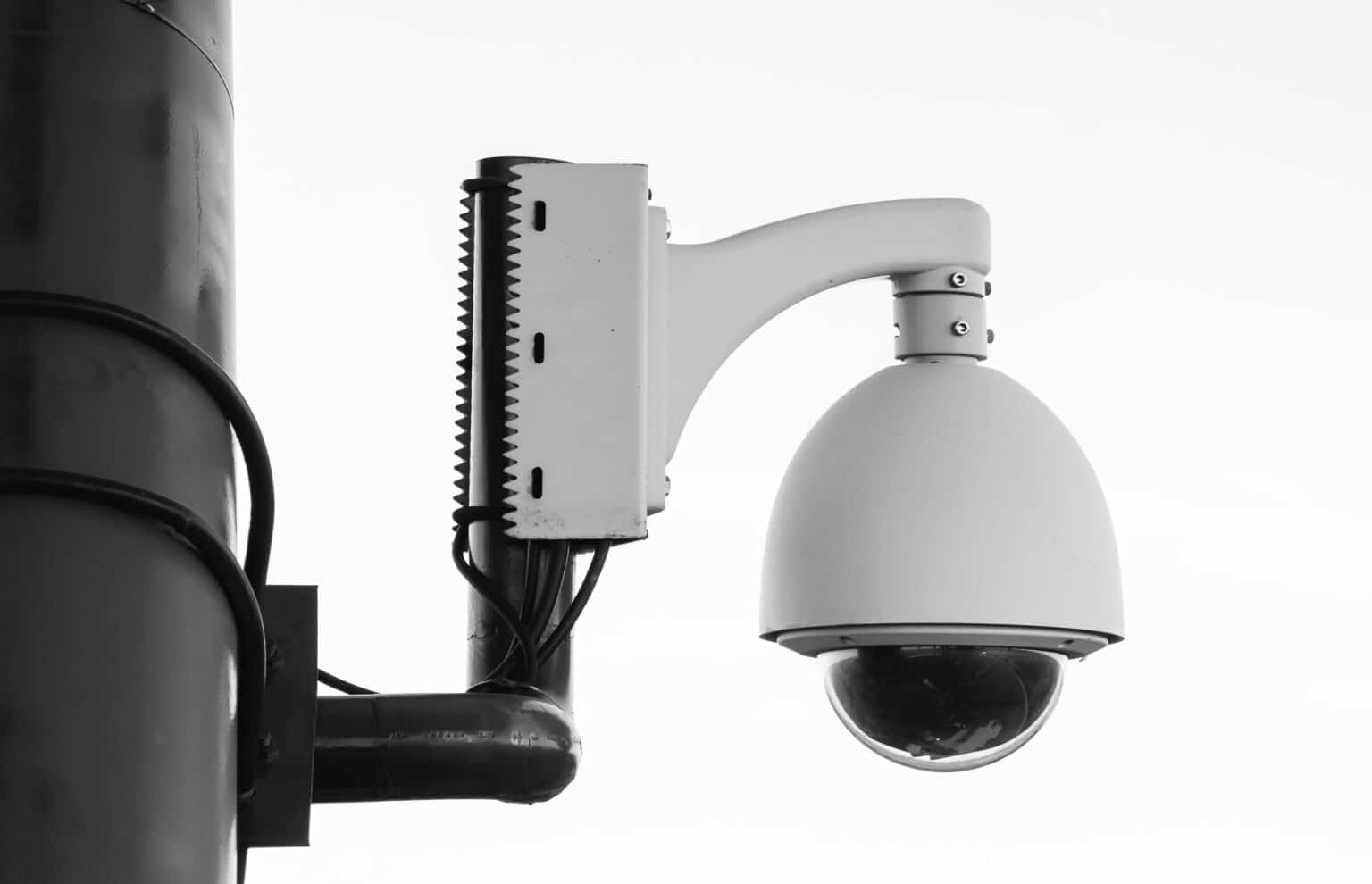 Mounted dome security cameras on a pole, providing wide-angle monitoring for property safety.