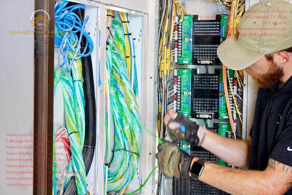 Technician wiring a control panel, demonstrating the technical foundation of home automation systems.
