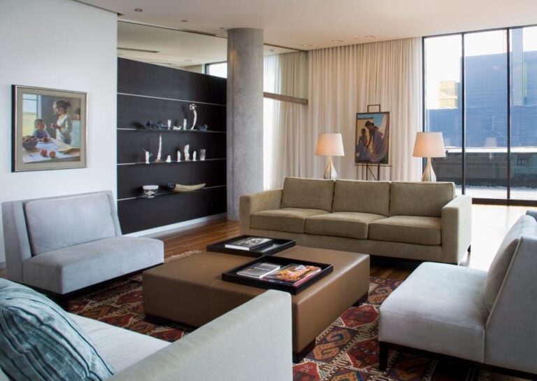 Modern living room with large windows, drapery, and elegant dÃ©cor, enhanced by integrated home automation solutions.