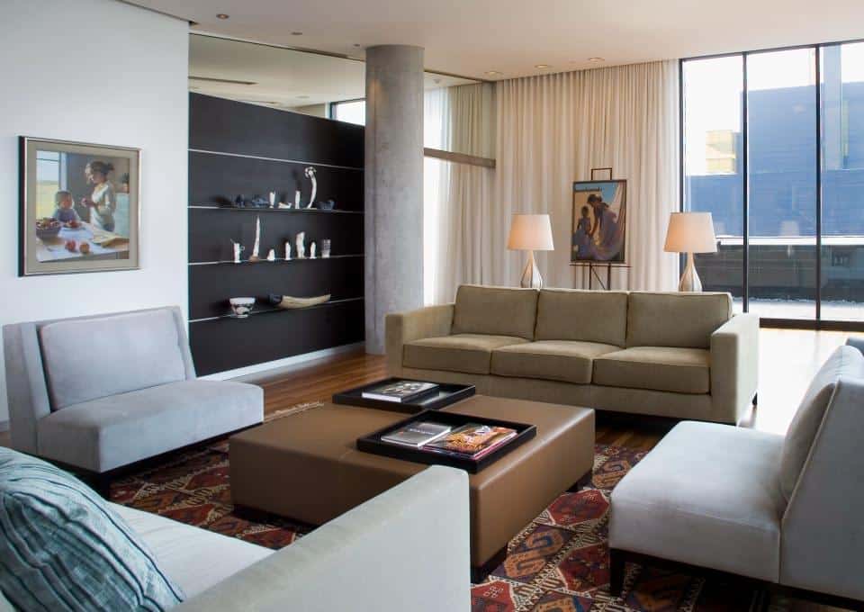 Modern living room with large windows, drapery, and elegant dÃ©cor, enhanced by integrated home automation solutions.